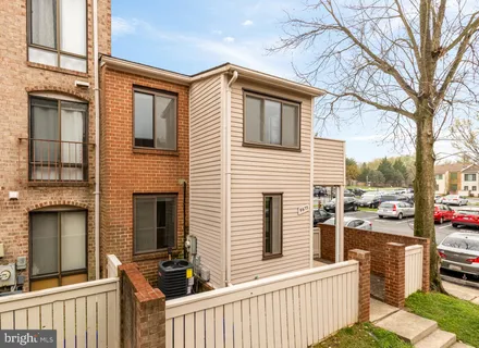 a view of a house with a small deck