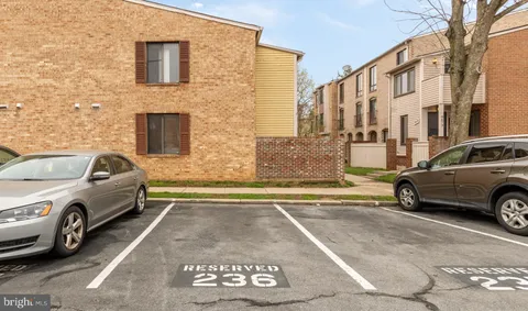 a view of a car parked in front of a brick house