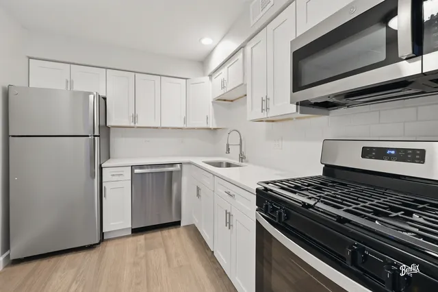 a kitchen with a stove and a refrigerator