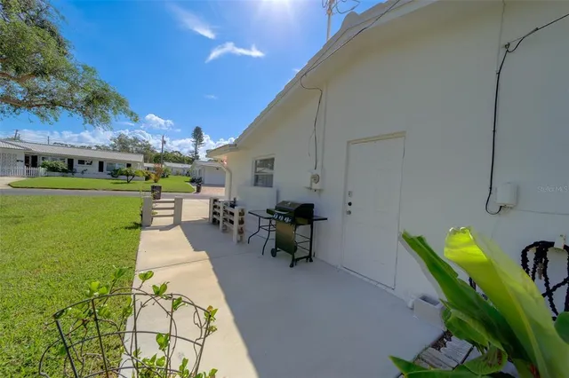 a view of a patio with a table and chairs