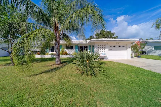 a view of a dining room with furniture and a book shelf