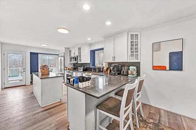 a large white kitchen with a stove and a sink