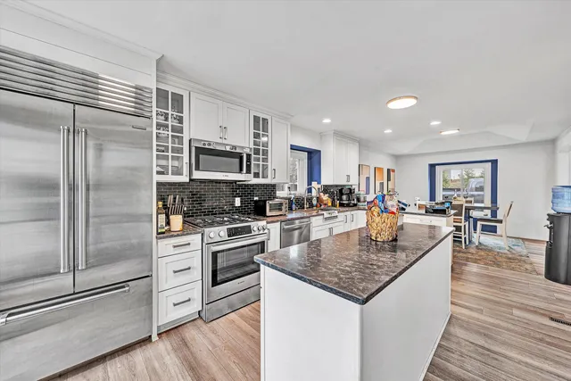 a spacious bathroom with a bathtub shower sink mirror and toilet