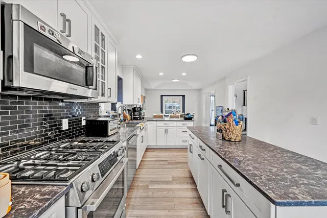 a bedroom with a bed and painting on the wall