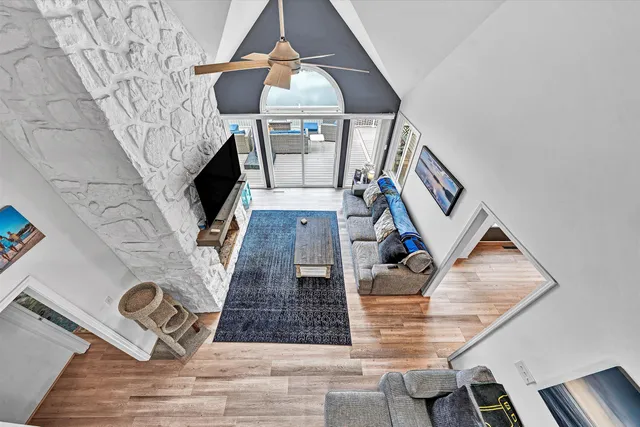 a dining room with furniture a wooden floor and windows