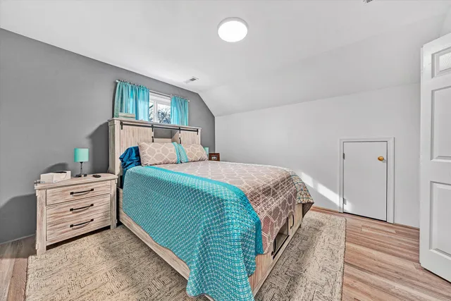 a living room with furniture a flat screen tv and a window