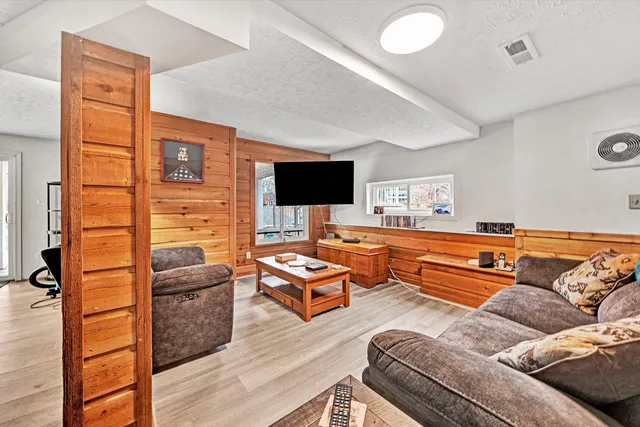 a view of a wooden balcony and trees
