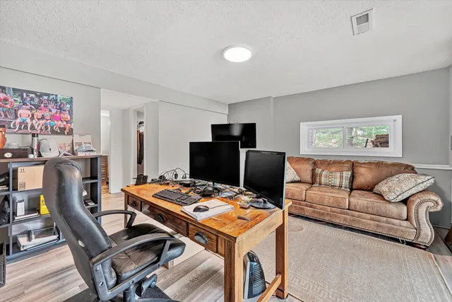 a living room with lots of furniture and a floor to ceiling window