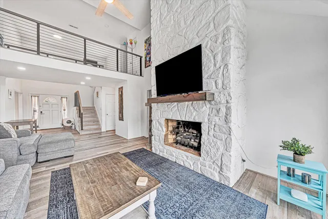 a kitchen with a dining table chairs and wooden floor