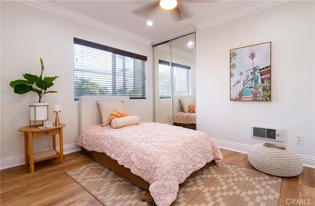 a bedroom with a bed and a potted plant