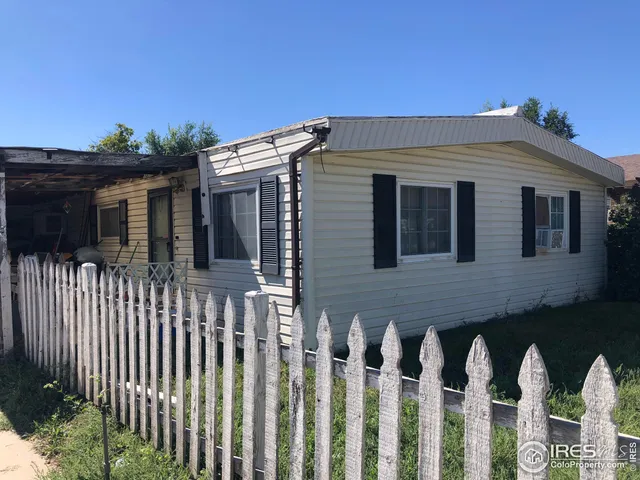 a view of a house with wooden fence