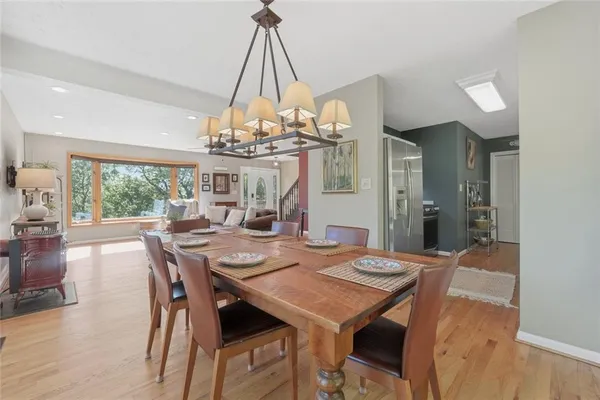 a view of a dining room with furniture a chandelier and wooden floor