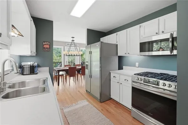 a kitchen with a stove a sink and a refrigerator