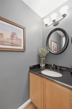 a bathroom with a toilet a sink and mirror