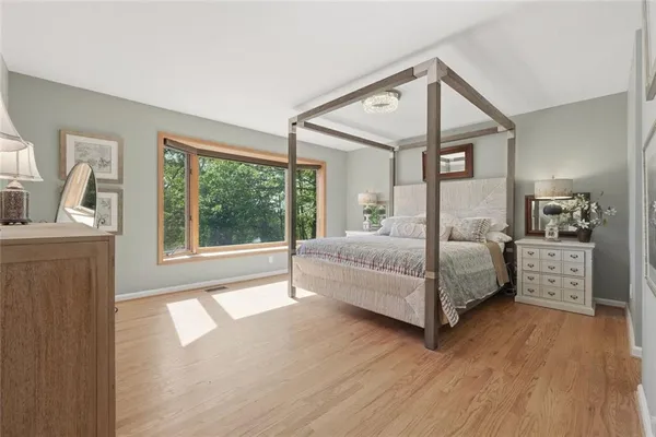 a bedroom with a large bed and a window