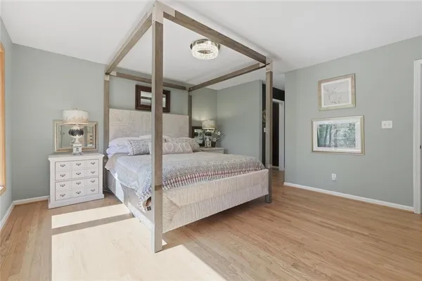 a bedroom with a large bed and a night stand