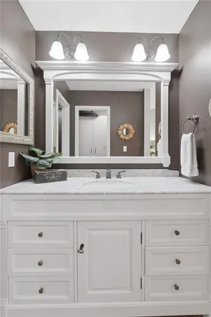 a bathroom with a sink mirror and vanity