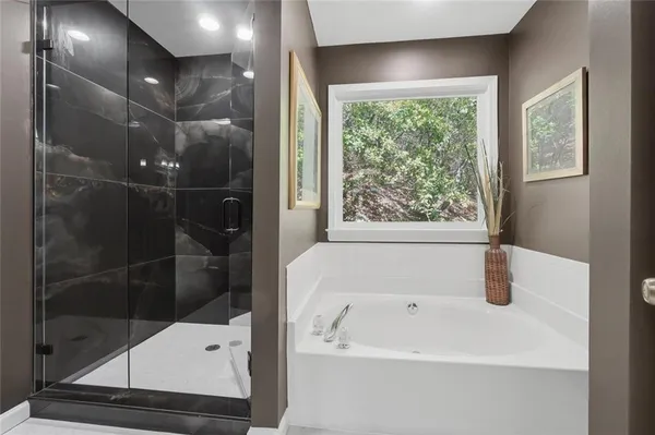 a bathroom with a tub and a shower