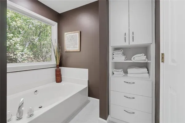 a bathroom with a bathtub and a window