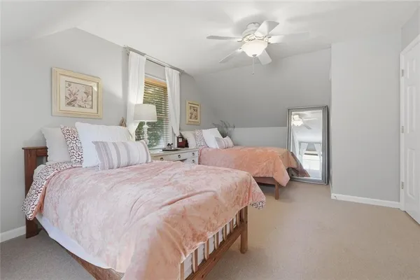a bedroom with bed and a chandelier