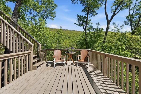 a view of balcony with furniture and trees