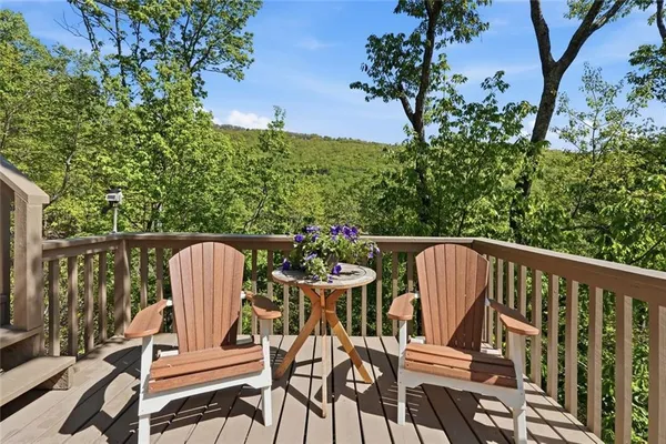 a view of balcony with wooden floor and outdoor seating