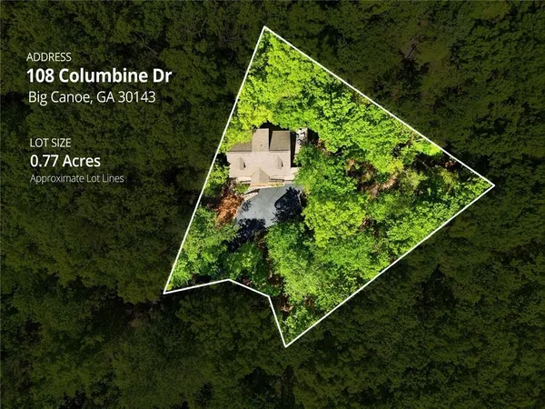 an aerial view of house with yard and mountain view in back