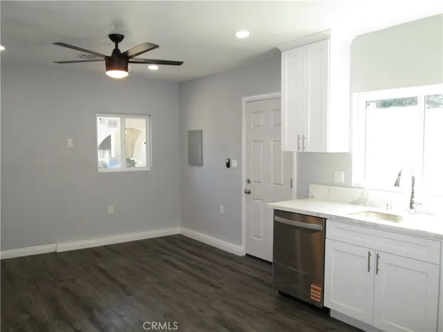 a kitchen with a sink cabinets stainless steel appliances and a window
