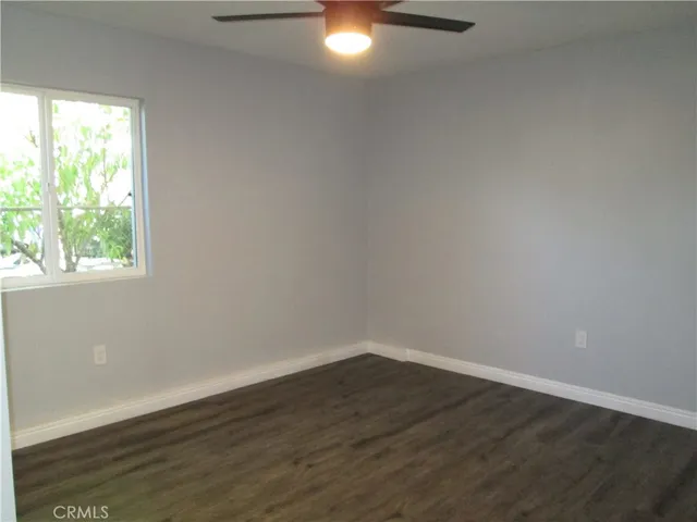 a view of a small space with wooden floor and a window