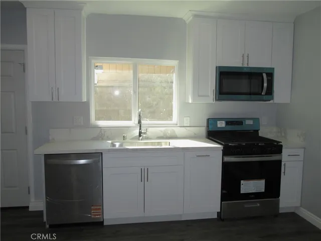 a kitchen with a stove and a microwave