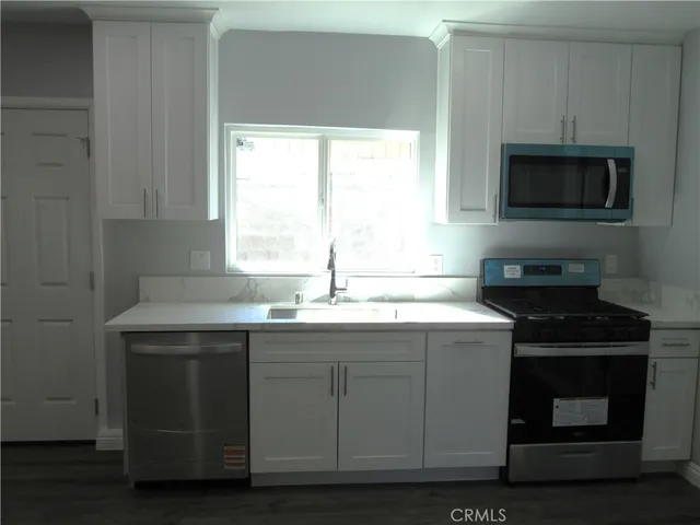 a kitchen with a sink and a microwave