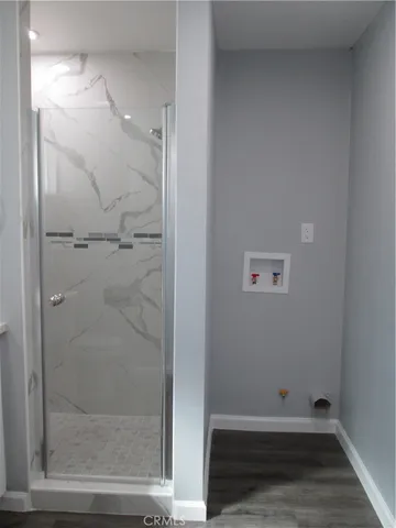 a bathroom with a glass shower door