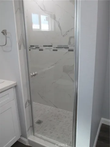 a bathroom with a glass shower door
