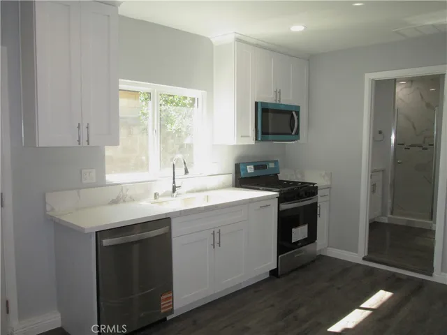 a kitchen with a sink and a refrigerator