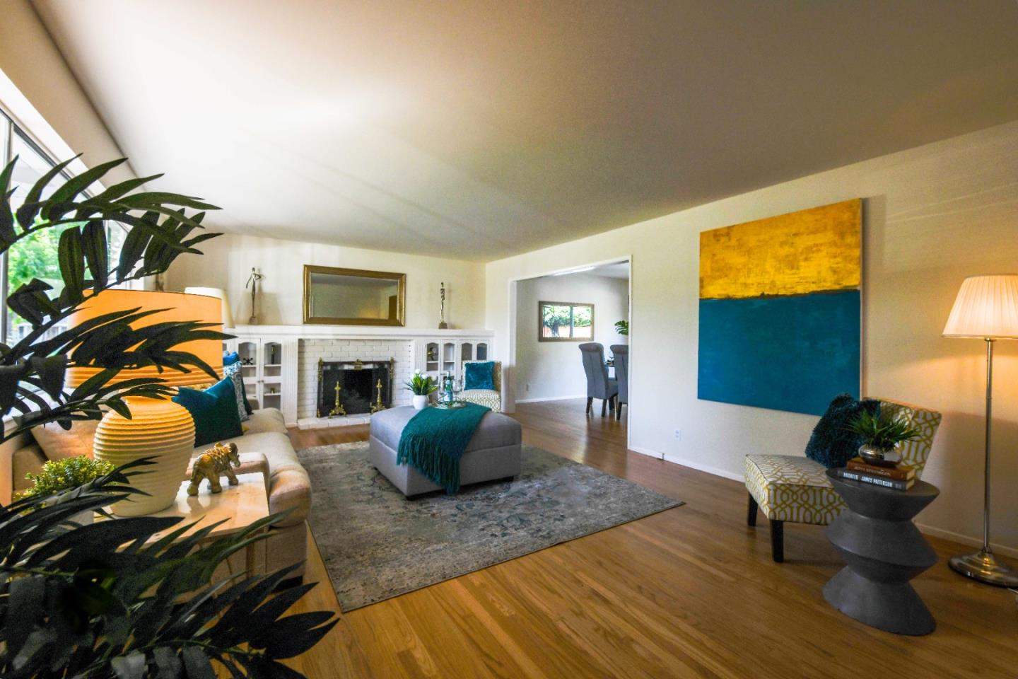 1130 Bruckner Circle Mountain View, CA 94040 - Photo 2 of 41 a living room with furniture a fireplace and a flat screen tv