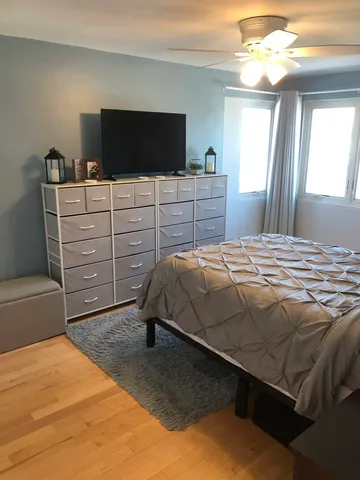a bedroom with a bed and a flat screen tv