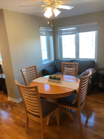 a dining room with furniture and window