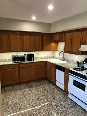a kitchen with a sink a stove and cabinets