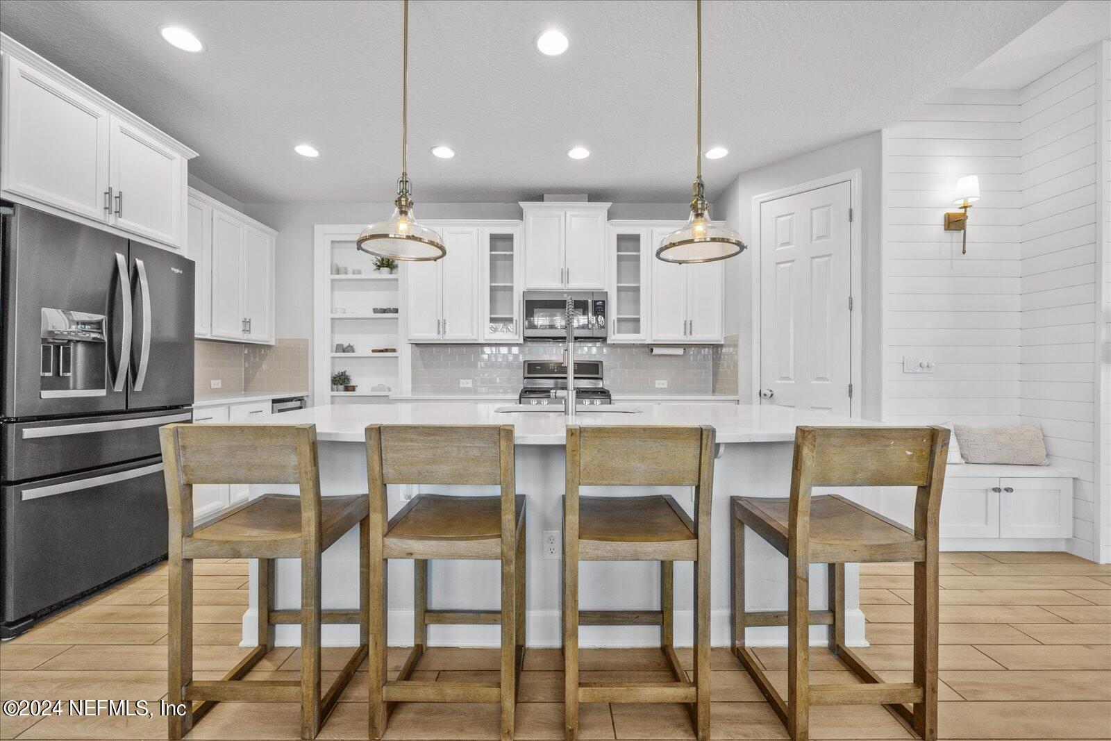 36 Foster Lane Ponte Vedra, FL 32081 - Photo 16 of 59 a kitchen with kitchen island white cabinets and stainless steel appliances