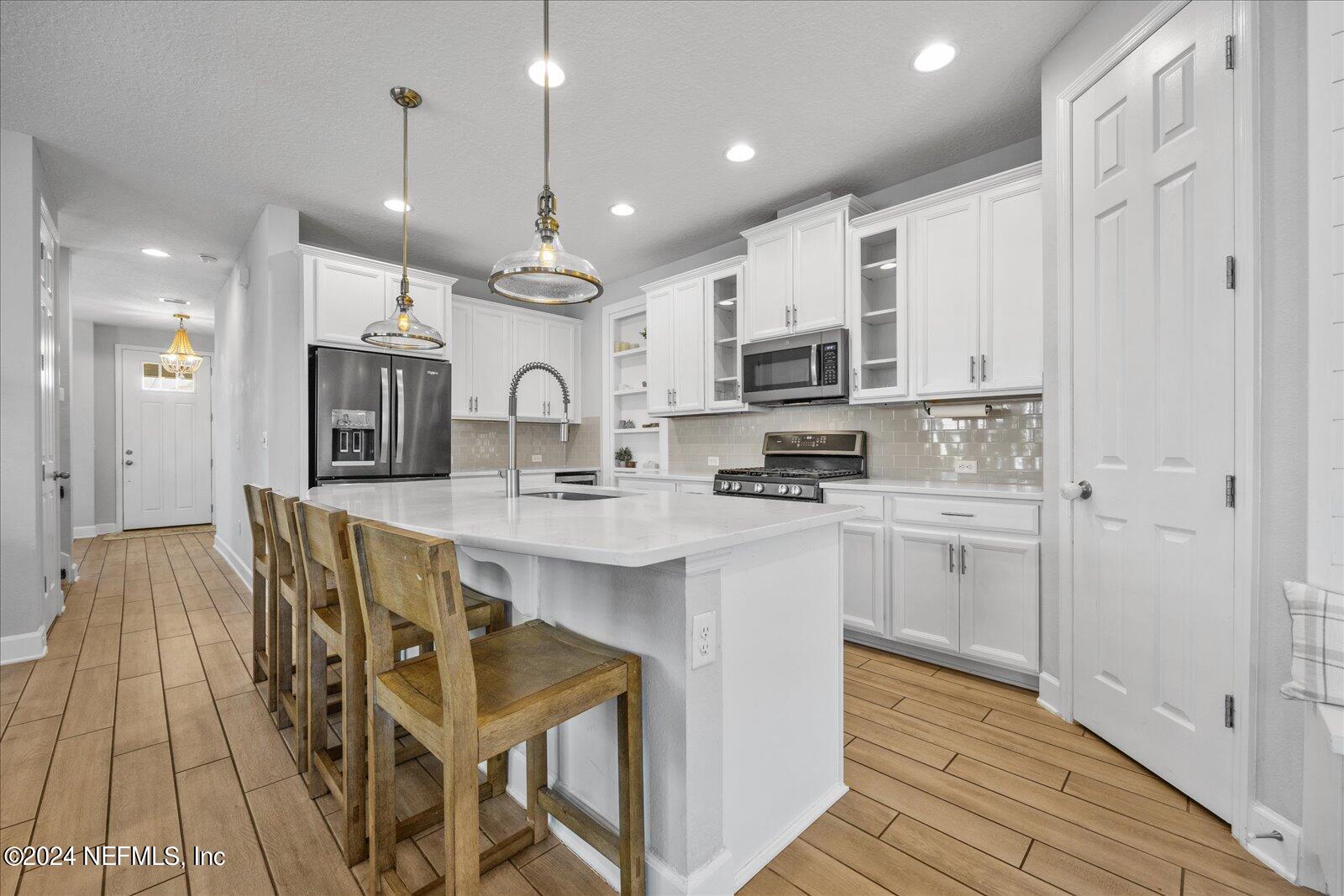 36 Foster Lane Ponte Vedra, FL 32081 - Photo 17 of 59 a large kitchen with cabinets chairs and stainless steel appliances
