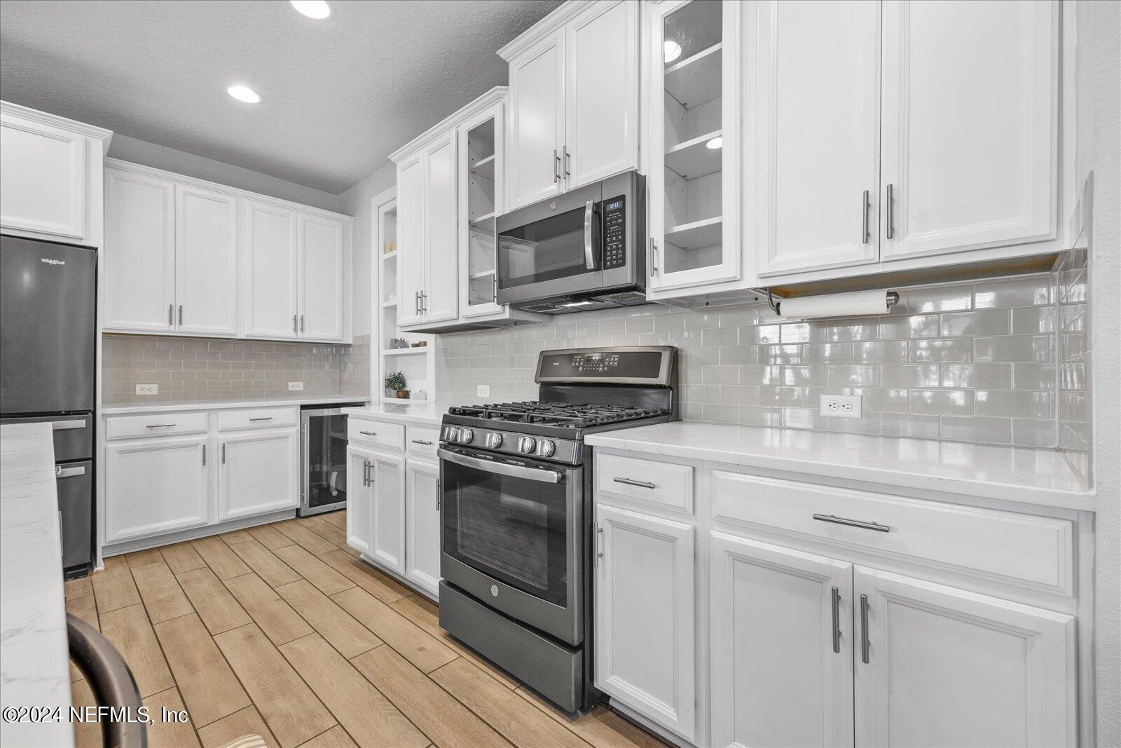 36 Foster Lane Ponte Vedra, FL 32081 - Photo 18 of 59 a kitchen with stainless steel appliances granite countertop a stove a sink and a microwave