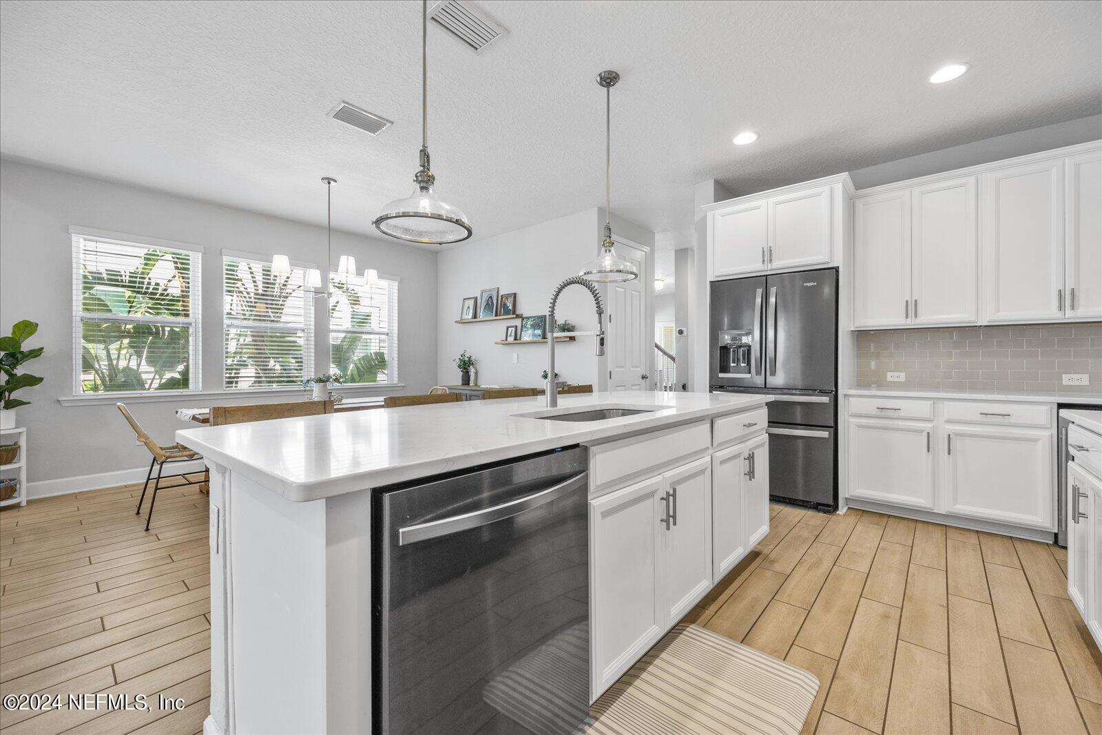 36 Foster Lane Ponte Vedra, FL 32081 - Photo 19 of 59 a kitchen with stainless steel appliances granite countertop a sink and cabinets