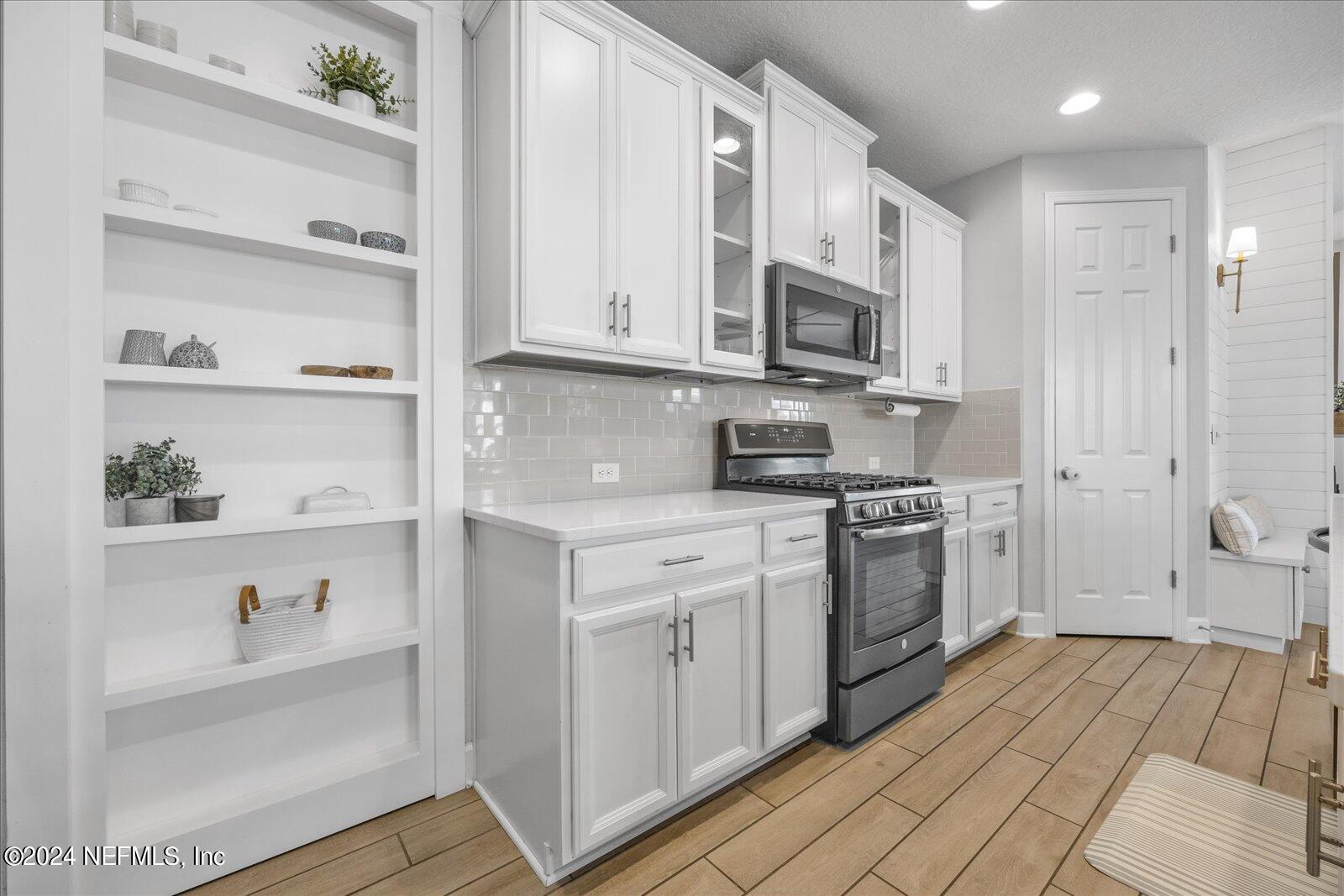 36 Foster Lane Ponte Vedra, FL 32081 - Photo 21 of 59 a kitchen with stainless steel appliances white cabinets and a refrigerator