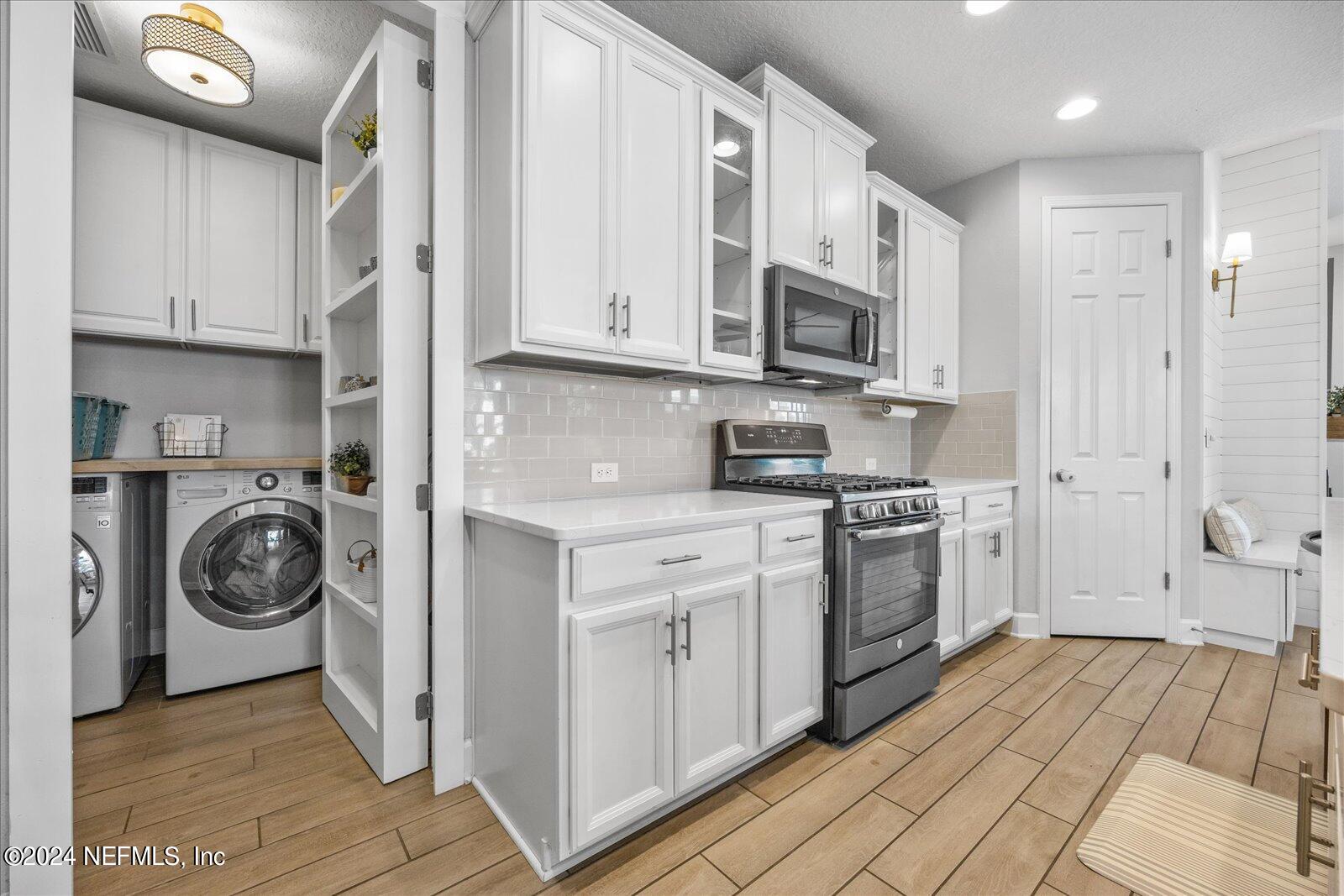36 Foster Lane Ponte Vedra, FL 32081 - Photo 23 of 59 a kitchen with a stove top oven sink and cabinets