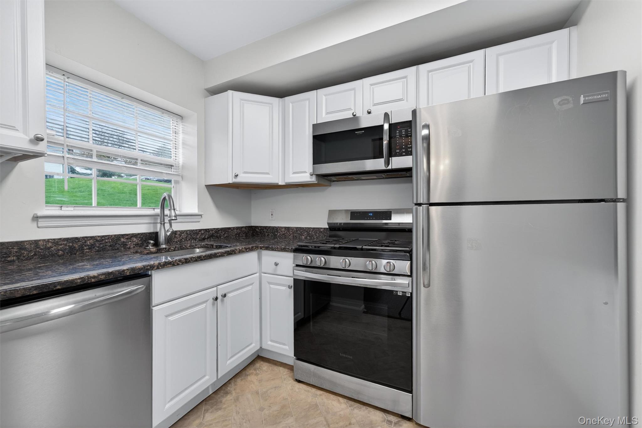 5 Lexington Hills Road, Unit 1 Harriman, NY 10926 - Photo 11 of 29 a kitchen with stainless steel appliances white cabinets white stove a microwave and a refrigerator