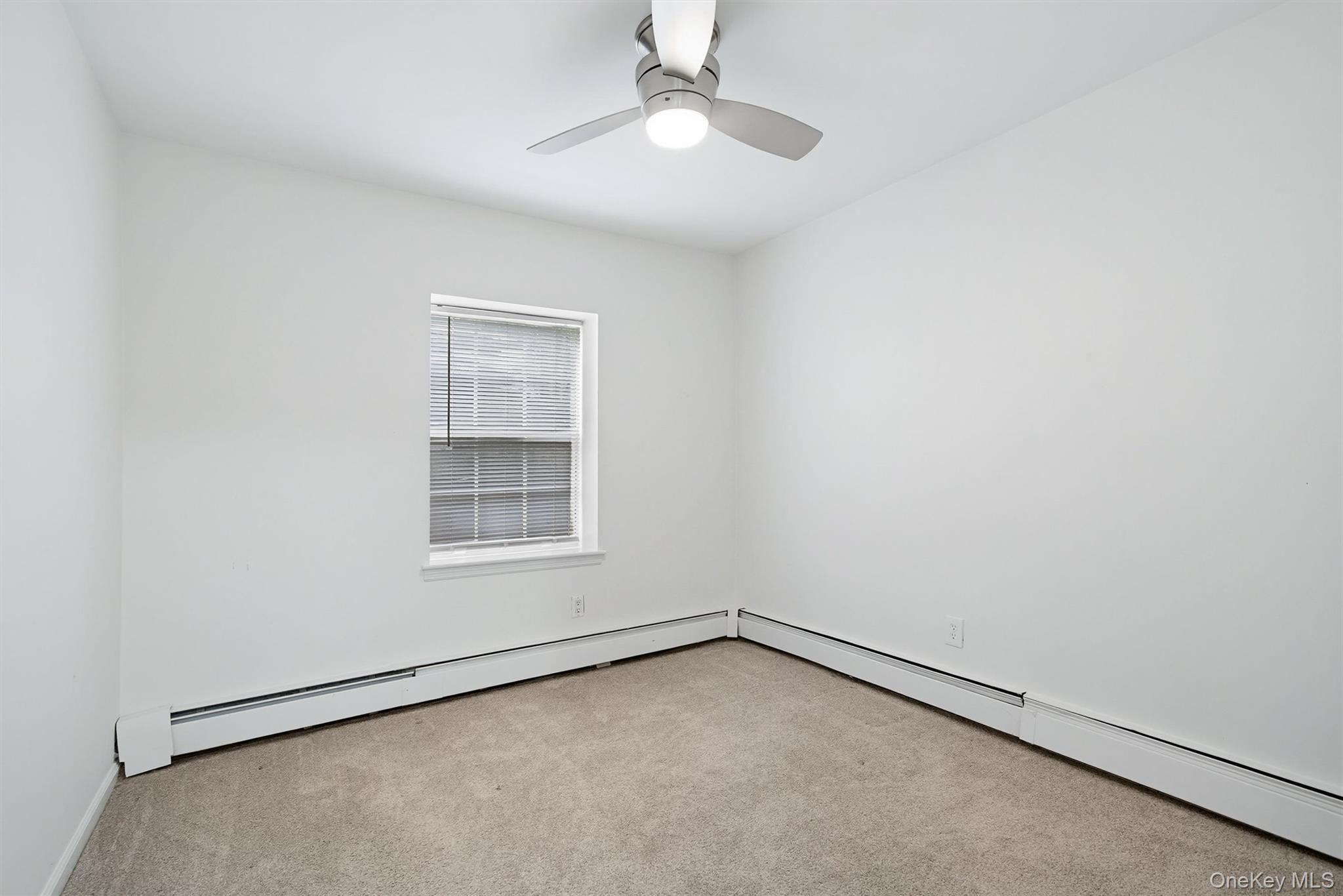5 Lexington Hills Road, Unit 1 Harriman, NY 10926 - Photo 17 of 29 an empty room with a window and ceiling fan
