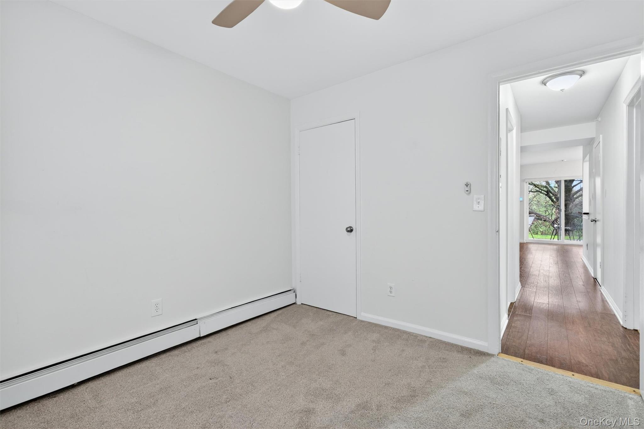 5 Lexington Hills Road, Unit 1 Harriman, NY 10926 - Photo 18 of 29 an empty room with wooden floor and windows