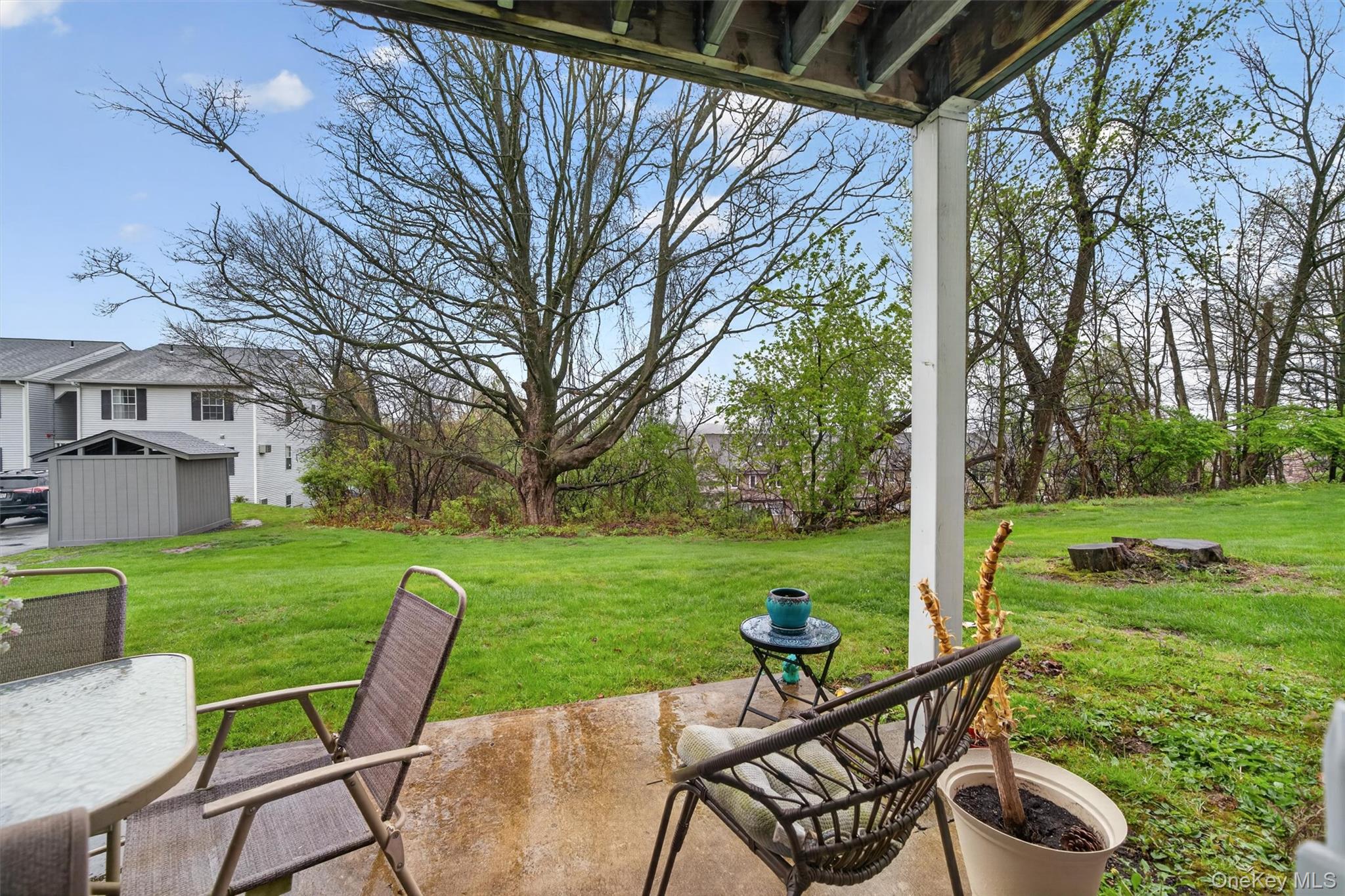 5 Lexington Hills Road, Unit 1 Harriman, NY 10926 - Photo 23 of 29 a view of a chair and table on the patio in front of a house