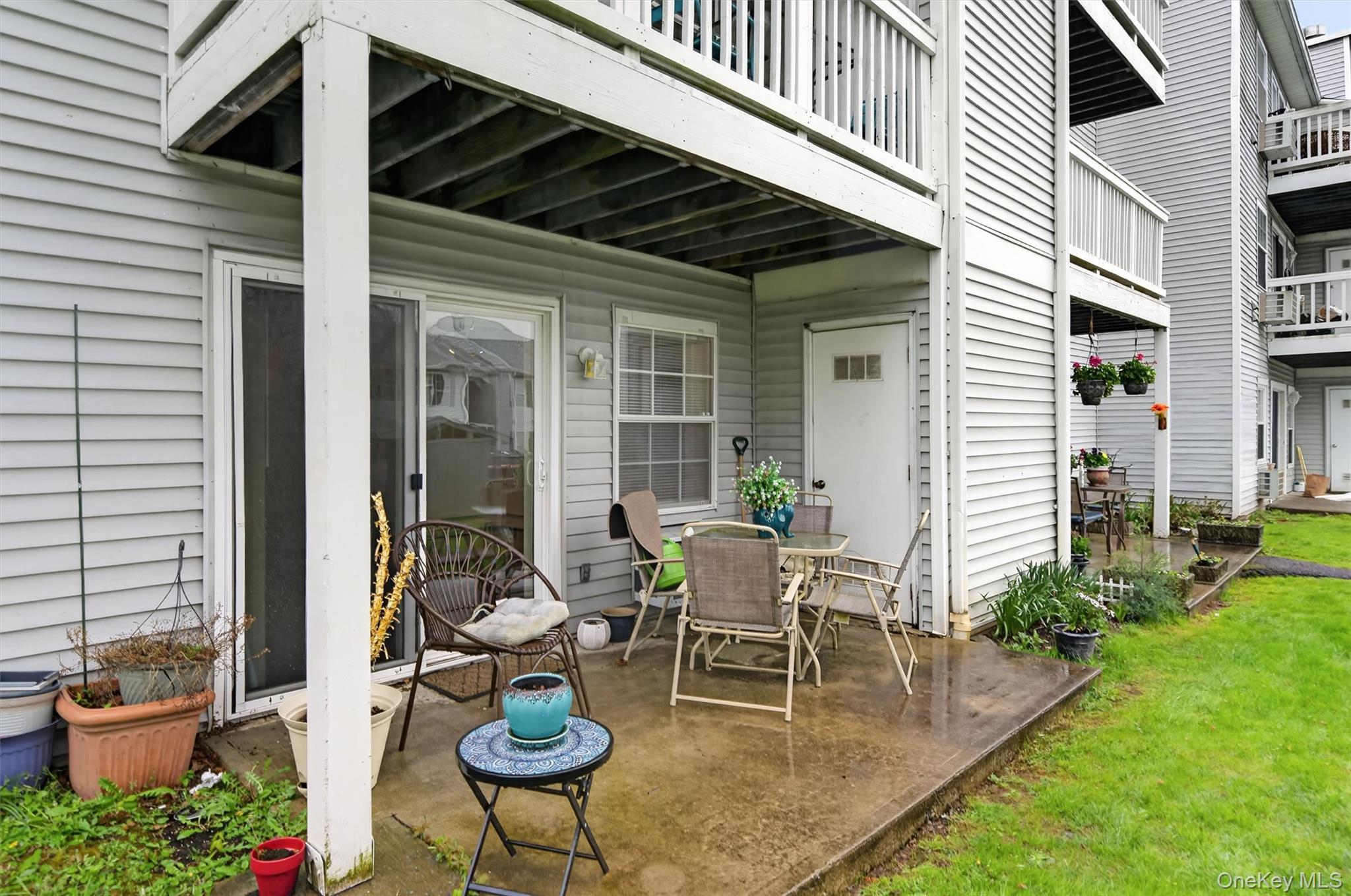 5 Lexington Hills Road, Unit 1 Harriman, NY 10926 - Photo 24 of 29 a patio with a table and chairs and potted plants