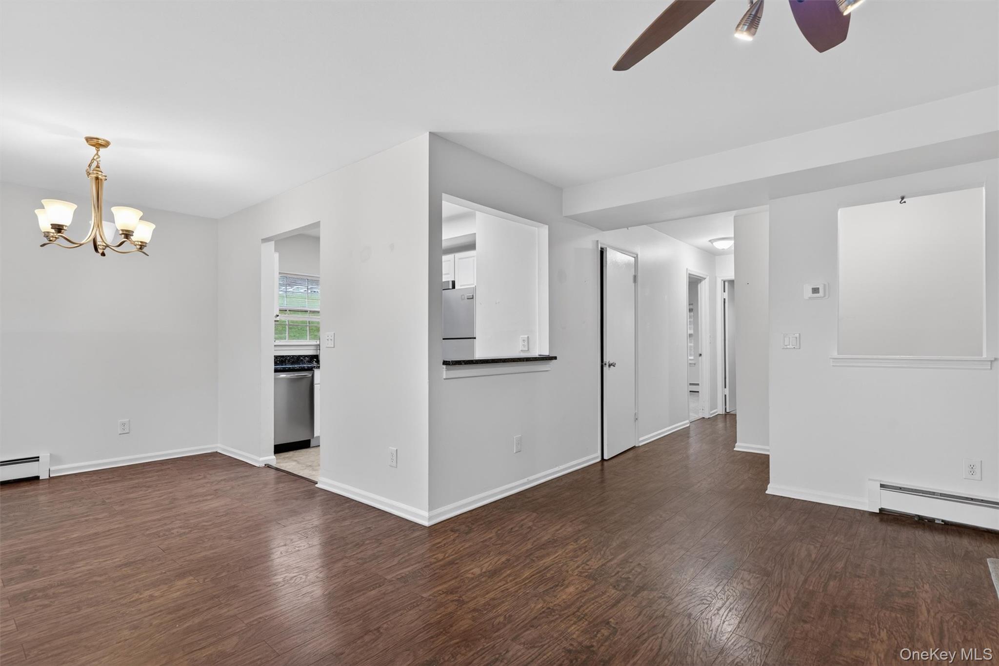 5 Lexington Hills Road, Unit 1 Harriman, NY 10926 - Photo 5 of 29 an empty room with wooden floor and ceiling fan